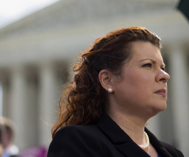 Lori Windham, the attorney representing Hobby Lobby, stands outside the Supreme Court in Washington, Monday, June 30, 2014, following the decision on the Hobby Lobby case. The Supreme Court says corporations can hold religious objections that allow them to opt out of the new health law requirement that they cover contraceptives for women.