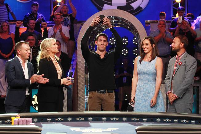 Daniel Colman holds up his bracelet after winning the final table of the Big One for One Drop tournament at the World Series of Poker on Tuesday, July 1, 2014, at the Rio. Colman is joined by Caesars Acquisitions CEO Mitch Garber, One Drop CEO Catherine B. Bachand and second-place winner Daniel Negreanu. Colman took home first place and $15,306,668 in prize money.