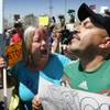 Photo: An unidentified protester, left, argues with Ameri Photo: An unidentified protester, left, argues with Ameri