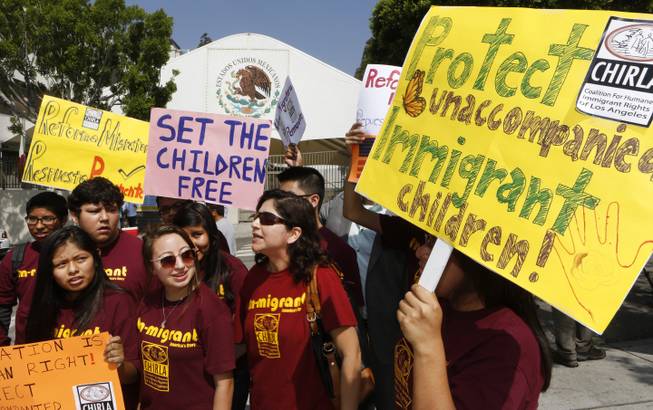 Immigration activists with Coalition for Humane Immigrant Rights of Los Angeles (CHIRLA) demand the Mexican government take more measures to protect and respect the rights of unaccompanied minors and families crossing Mexico's territory, during a protest outside the Mexican consulate in Los Angeles Thursday, July 3, 2014. Activists demand support of migrant children and families Thursday, two days after U.S. Homeland Security buses carrying the migrants were routed away from American flag-waving protesters in Murrieta, Calif., and transported to a facility in San Diego.