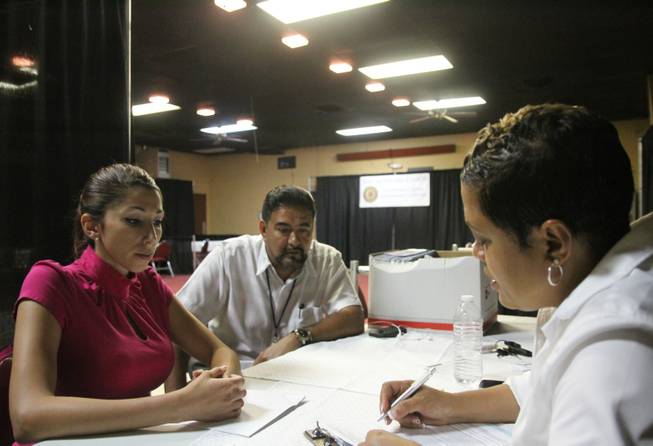 Veteran Rebecca King, left, talks with Veterans Affairs employee Joe Esparza, center, and American Legion official Verna Jones at the American Legion in El Paso, Texas.The American Legion is hosting crisis centers in different cities to help veterans get doctor’s appointments and benefits from the Department of Veterans Affairs.