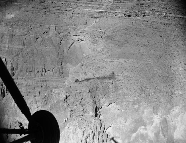 FILE - In this July 3, 1956, file photo, a burned area shows where a United Airlines UAL DC-7 crashed on Saturday, June 30, 1956, after a mid-air collision with a TWA Flight 2 Constellation, killing a total of 128 people. Wreckage lies at top of butte with vertical cliffs on each side. On Tuesday, July 8, 2014, the Grand Canyon National Park will mark the designation of the crash site as a National Historic Landmark in a ceremony overlooking the gorge where the wreckage was scattered over 1.5 square miles.