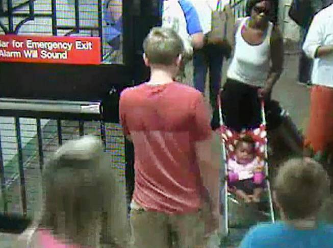 In this Monday, July 7, 2014 surveillance camera image provided by the New York Police Department, a woman, top right, pushes her baby girl in a stroller at the Columbus Circle subway station in New York. The 20-year-old woman, who is suspected of abandoning the baby at the Manhattan station, was in police custody on Tuesday.