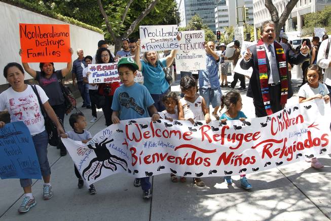 Immigrant families and children's advocates rally in response to President Barack Obama's statement on the crisis of unaccompanied children and families illegally entering the United States, outside the Los Angeles Federal building Monday, July 7, 2014. A top Obama administration official says no one, not even children trying to escape violent countries, can illegally enter the United States without eventually facing deportation proceedings.