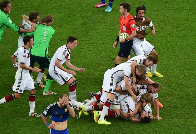 German players celebrate after winning the World Cup final soccer match between Germany and Argentina at the Maracana Stadium in Rio de Janeiro, Brazil, Sunday, July 13, 2014. Mario Goetze volleyed in the winning goal in extra time to give Germany its fourth World Cup title with a 1-0 victory over Argentina on Sunday.