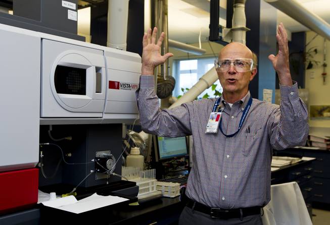 Compliance manager Stan Van Wagenen describes the process for using the Vista-MPX machine allowing simultaneous measurement of all elements from parts-per-billion to percent levels within the Southern Nevada Water Authority (SNWA) massive testing facility out near Lake Mead on Wednesday, July 9, 2014.
