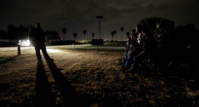 In this June 25, 2014 photo, a group of immigrants from Honduras and El Salvador who crossed the U.S.-Mexico border illegally are stopped in Granjeno, Texas. Just since October, the Border Patrol’s Rio Grande Valley sector has made more than 194,000 arrests, nearly triple that of any other sector. Most are from Central America, and many are children.
