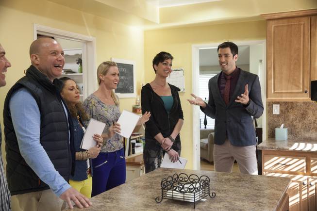 Interior designer Melissa Roche of Las Vegas competes in Season 2 of “Brother vs. Brother” on HGTV. Drew Scott, right, talks with his team, from left, Thomas Brown, Eric Eremita, Drea Clark, Roche and Six about the potential for improving the Hodge house in Northridge, Calif. Roche was crowned the champion on the finale Sunday, July 13, 2014.