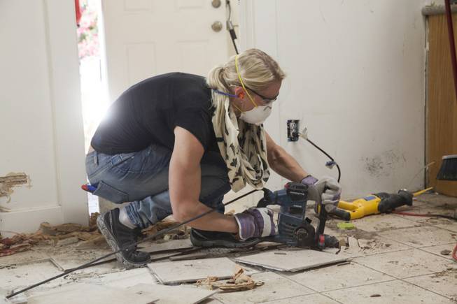 Interior designer Melissa Roche of Las Vegas competes in Season 2 of “Brother vs. Brother” on HGTV. Roche, pictured here, breaks up the tile floor in the kitchen of the McMahan home in the Arlington Heights neighborhood of Los Angeles. Roche, part of Team Drew, was crowned the champion on the finale Sunday, July 13, 2014.