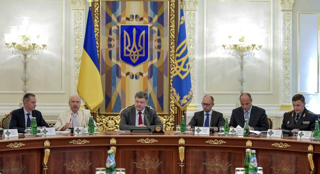 Ukrainian President Petro Poroshenko, third left, chairs a Security Council meeting in Kiev, Ukraine, Thursday, July 17, 2014. Ukrainian President Petro Poroshenko called the downing of a Malaysia Airlines passenger plane an act of terrorism and called for an international investigation into the crash. Poroshenko insisted that his forces did not shoot down the plane. From right, Ukrainian Defense MInister Valery Heletey, Head of the Security Council Andriy Parubiy, Prime Minister Arseniy Yatsenyuk, Petro Poroshenko, parliament speaker Oleksandr Turchynov.