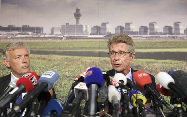 Huib Gorter, senior vice-president of Malaysia Airlines, right, speaks at a press conference as Jos Nijhuis, president and CEO of Schiphol, left, listens, at Schiphol airport in Amsterdam, Thursday, July 17, 2014. An official with Malaysia Airlines says at least one Canadian was among the 295 people aboard a passenger plane that was downed today over Ukraine. Gorter says 154 people were Dutch, 27 were Australians, 23 were Malaysians, 11 were Indonesian, 6 were from the United Kingdom, 4 were from Germany, 4 were from Belgium, and 3 were from the Philippines. Gorter says authorities are still trying to determine the nationalities of the rest of the passengers.