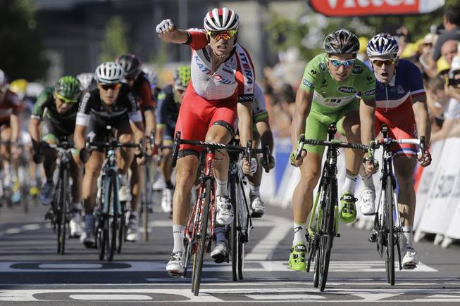 Norway's Alexander Kristoff crosses the finish line ahead of Peter Sagan of Slovakia, second right, and France's Arnaud Demare, right, to win the twelfth stage of the Tour de France cycling race over 185.5 kilometers (115.3 miles) with start in Bourg-en-Bresse and finish in Saint-Etienne, France, Thursday, July 17, 2014.