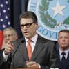 Photo: Gov. Rick Perry, center, speaks during a news conf Photo: Gov. Rick Perry, center, speaks during a news conf
