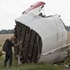 Photo: A Malaysian air crash investigator takes pictures Photo: A Malaysian air crash investigator takes pictures
