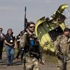 Photo: Pro-Russian rebels, right, followed by members of Photo: Pro-Russian rebels, right, followed by members of