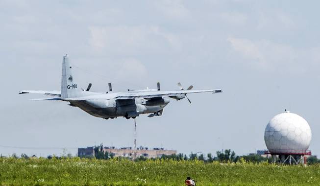 A Dutch cargo plane loaded with coffins holding the bodies of some of the Malaysian Airlines plane passengers, leaves for the Netherlands from Kharkiv airport, Ukraine, Wednesday, July 23, 2014. The Dutch government has declared Wednesday a day of national mourning as the country prepares for the arrival of the first bodies of victims of the downed Malaysia Airlines Flight 17.