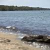 Photo: In this July 2, 2014, photo, people swim in the wa Photo: In this July 2, 2014, photo, people swim in the wa