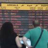 Photo: An arrivals flight board displays various canceled Photo: An arrivals flight board displays various canceled