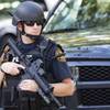 Photo: An officer stands guard near the scene of a shooti Photo: An officer stands guard near the scene of a shooti