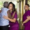 Photo: A hospital worker embraces a woman near the scene Photo: A hospital worker embraces a woman near the scene