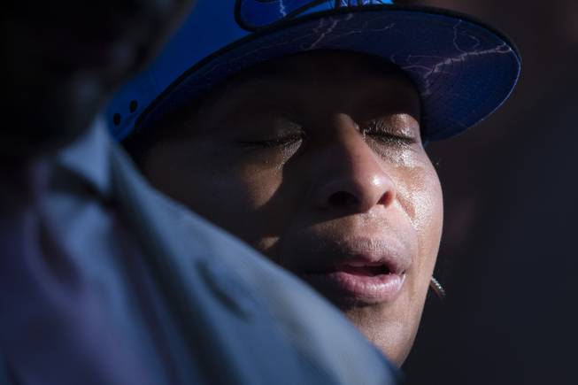 AP10ThingsToSee - Ellisha Flagg, sister of Eric Garner, cries during a vigil demanding justice for Eric Garner, a Staten Island man who died while being arrested by New York City police, Tuesday, July 22, 2014, in New York. Demonstrators gathered at a park Tuesday, near where police attempted to arrest Garner on suspicion of selling untaxed cigarettes.
