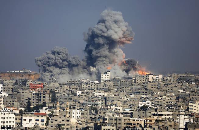 Smoke and fire from the explosion of an Israeli strike rise over Gaza City, Tuesday, July 29, 2014. Israel escalated its military campaign against Hamas on Tuesday, striking symbols of the group's control in Gaza and firing tank shells that shut down the strip's only power plant in the heaviest bombardment in the fighting so far. The plant’s shutdown was bound to lead to further serious disruptions of the flow of electricity and water to Gaza’s 1.7 million people.