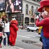 Photo: A visitor to Times Square stands for photos with c Photo: A visitor to Times Square stands for photos with c