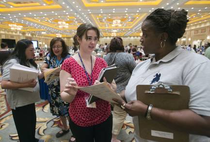 Teacher Amanda Ford, center, talks with Candy Smith, service director for the Teachers Health Trust, during a Clark County School District orientation session for new teachers at the Venetian on Thursday, Aug. 15, 2013.
