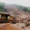 Photo: Mud and slush surround a building after a mudslide Photo: Mud and slush surround a building after a mudslide