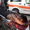 Photo: Palestinian medics wheel a wounded man, following Photo: Palestinian medics wheel a wounded man, following