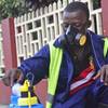 Photo: An employee of the Monrovia City Corp. mixes disin Photo: An employee of the Monrovia City Corp. mixes disin