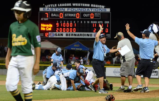 Nevada players and coaches celebrate after defeating Pacifica 11-2 Saturday night to win the Little League Western Regional Championship. Mountain Ridge Little League, from Las Vegas, Nevada, defeated Pacifica Little League 11-2 Saturday August 9, 2014 in the Little League Western Regional Championship game at Al Houghton Stadium in San Bernardino. Nevada will play at the Little League World Series in Williamsport, PA. starting next week. (Will Lester/Staff Photographer)