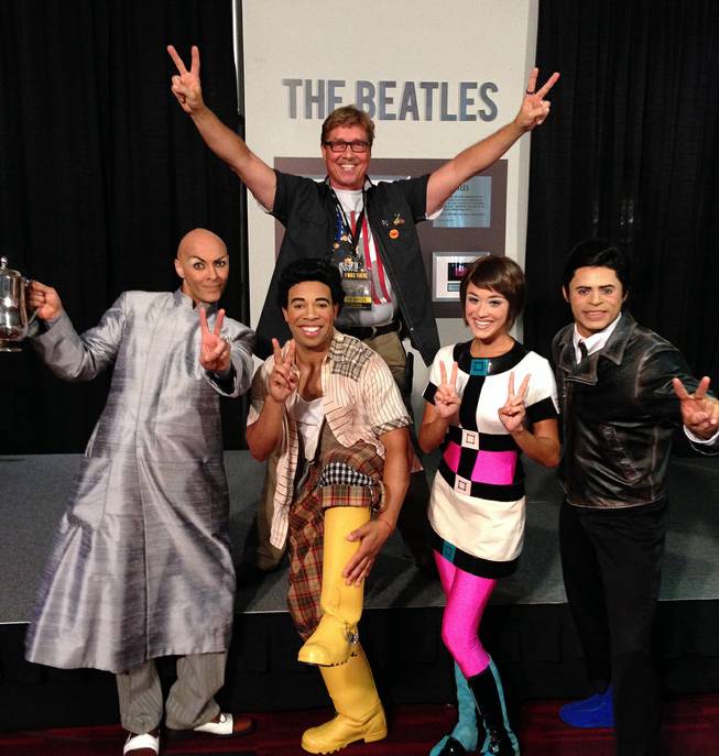 Stuart Pitz, assistant head of lighting at "Love" at the Mirage, poses with cast members of the Cirque production at the Las Vegas Convention Center on Tuesday, Aug. 12, 2014. Pitz was invited to the celebration of the 50th anniversary of the Beatles' two performances at the Convention Center on Aug. 20, 1964, as he saw the band that night when he was just 9 years old.