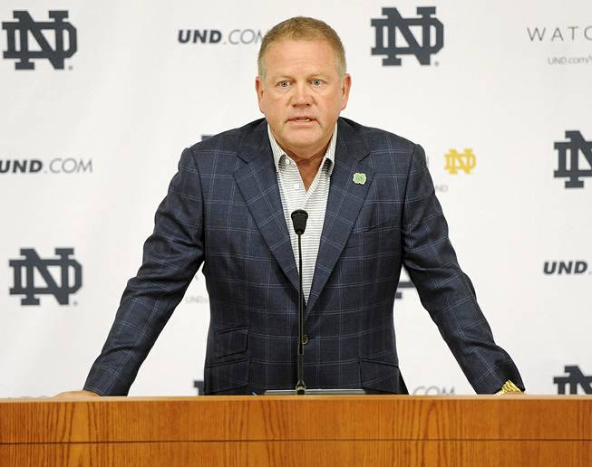 In this Aug. 1, 2014, file photo, Notre Dame football coach Brian Kelly talks to the media at the beginning of fall practice in South Bend, Ind. Notre Dame says it is investigating "suspected academic dishonesty" involving several students, including four members of the football team.