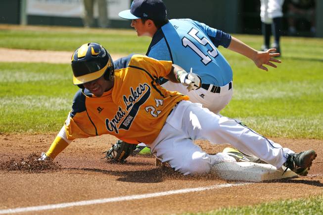 Chicago's Trey Hondras (24) steals third ahead of the tag by Las Vegas third baseman Dillon Jones (15) during the first inning of a baseball game in United States pool play at the Little League World Series tournament in South Williamsport, Pa., Sunday, Aug. 17, 2014.
