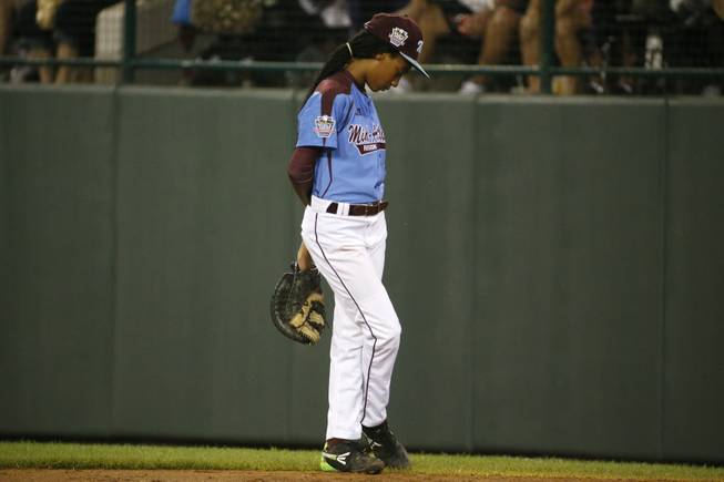 Philadelphia pitcher Mo'ne Davis stands at first base after being removed as pitcher in the third inning of a United States semi-final baseball game against Las Vegas at the Little League World Series tournament in South Williamsport, Pa., Wednesday, Aug. 20, 2014. (AP Photo/Gene J. Puskar)