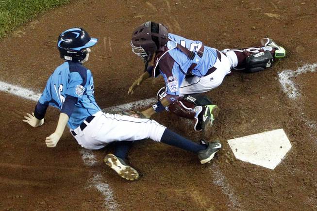 Las Vegas' Brad Stone (16) is tagged out by Philadelphia catcher Scott Bandura while attempting to score on a single by Austin Kryszczuk in the in the thirdinning of a United States semi-final baseball game at the Little League World Series tournament in South Williamsport, Pa., Wednesday, Aug. 20, 2014. Las Vegas won 8-1. (AP Photo/Gene J. Puskar)