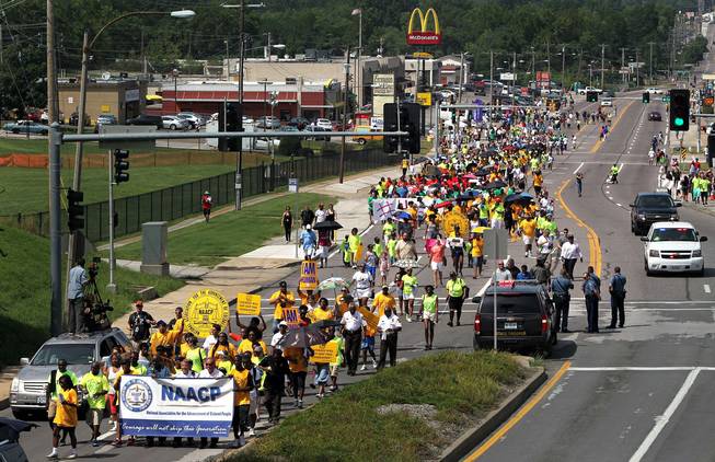 Members of the St. Louis chapters of the NAACP and the National Urban League march on West Florissant Avenue in Ferguson, Mo., on Saturday, Aug. 23, 2014. Ferguson's streets remained peaceful as tensions between police and protesters continued to subside after nights of violence and unrest that erupted when Officer Darren Wilson, a white police officer, fatally shot Michael Brown, an unarmed black 18-year-old.