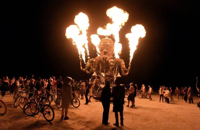 In this Aug. 27, 2014 photo, participants enjoy the Burning Man festival on the Black Rock Desert in Gerlach, Nev. Organizers call Burning Man the largest outdoor arts festival in North America, with its drum circles, decorated art cars, guerrilla theatrics and colorful theme camps.