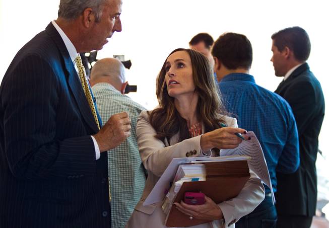 District Attorney Steven Wolfson and Chief Deputy District Attorney Jacqueline Bluth confer outside the courtroom on Wednesday, September 3, 2014. They began the prosecution of Jon Koppenhaver now facing multiple felony charges, including assault with a deadly weapon, lewdness, coercion and multiple counts of battery. L.E. Baskow