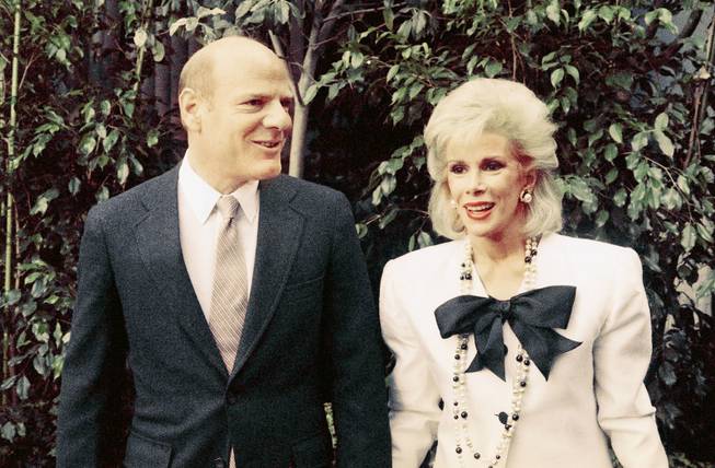 Comedian Joan Rivers and Barry Diller, chairman of Fox Inc., arrive for news conference in Los Angeles to announce that she will host a live talk show on Fox Broadcasting Co. that will compete with late night king Johnny Carson, May 6, 1986. Miss Rivers will lead the attack for Fox Broadcasting Corps new fourth network.