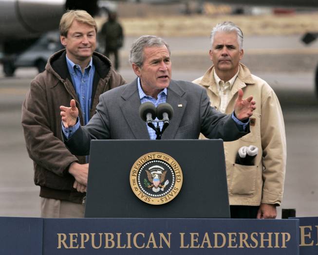 President Bush gestures while addressing a crowd at a campaign rally in Elko, Nev., Thursday, Nov. 2, 2006. Bush stopped to campaign for Nevada Secretary of State Dean Heller, left, who is seeking a seat a Congressional seat and Sen. John Ensign, right, who is up for re-election.(AP Photo/Rich Pedroncelli)