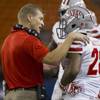UNLV coach Bobby Hauck, left, talks with running back Keith Whitely (28) during a timeout in the first quarter of an NCAA college football game against Hawaii, Saturday, Nov. 22, 2014, in Honolulu. UNLV coach Bobby Hauck, left, talks with running back Keith Whitely (28) during a timeout in the first quarter of an NCAA college football game against Hawaii, Saturday, Nov. 22, 2014, in Honolulu.