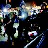 Photo: A man is arrested as police try to disperse a crow Photo: A man is arrested as police try to disperse a crow