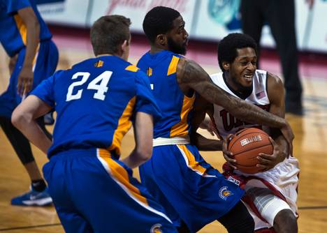 UNLV guard Barry Cheaney (12) takes a hard foul on the way to a basket from SJS forward Jaleel Williams (2) with teammate SJS forward Ryan Singer (24) near during their basketball game at the Thomas & Mack Center on Saturday, January 10, 2015. L.E. Baskow.