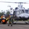 Photo: Indonesian military personnel unload the bodies be Photo: Indonesian military personnel unload the bodies be