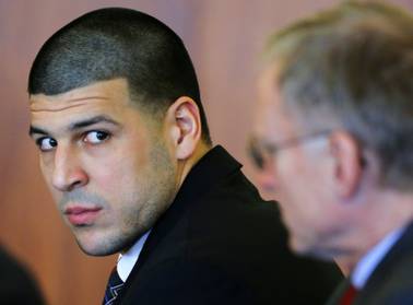 In this Dec. 22, 2014, file photo, former New England Patriots tight end Aaron Hernandez, left, attends a pretrial hearing in Fall River, Mass. Hernandez is accused of murdering semi-professional football player Odin Lloyd. A jury is expected to be seated for opening arguments in his murder trial as early as Tuesday, Jan. 27, 2015.