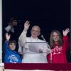 Photo: Pope Francis, flanked by children, waves to faithf Photo: Pope Francis, flanked by children, waves to faithf
