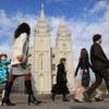 Photo: In this April 5, 2014, photo, people walk past the Photo: In this April 5, 2014, photo, people walk past the