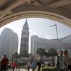 In this photo taken Nov. 23, 2014, visitors walk across the road in front of the Venetian Macao casino resort in Macau. In this photo taken Nov. 23, 2014, visitors walk across the road in front of the Venetian Macao casino resort in Macau.